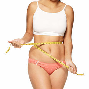 The overweight girl measured her waist